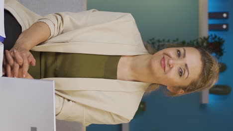 Vertical-video-of-Home-office-worker-woman-looking-smugly-at-camera.